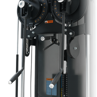 Close-up of a gym machine with pulleys and weight settings on a white background